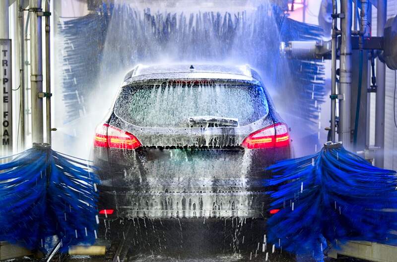 Car going through Rainforest express car wash tunnel — Mississippi